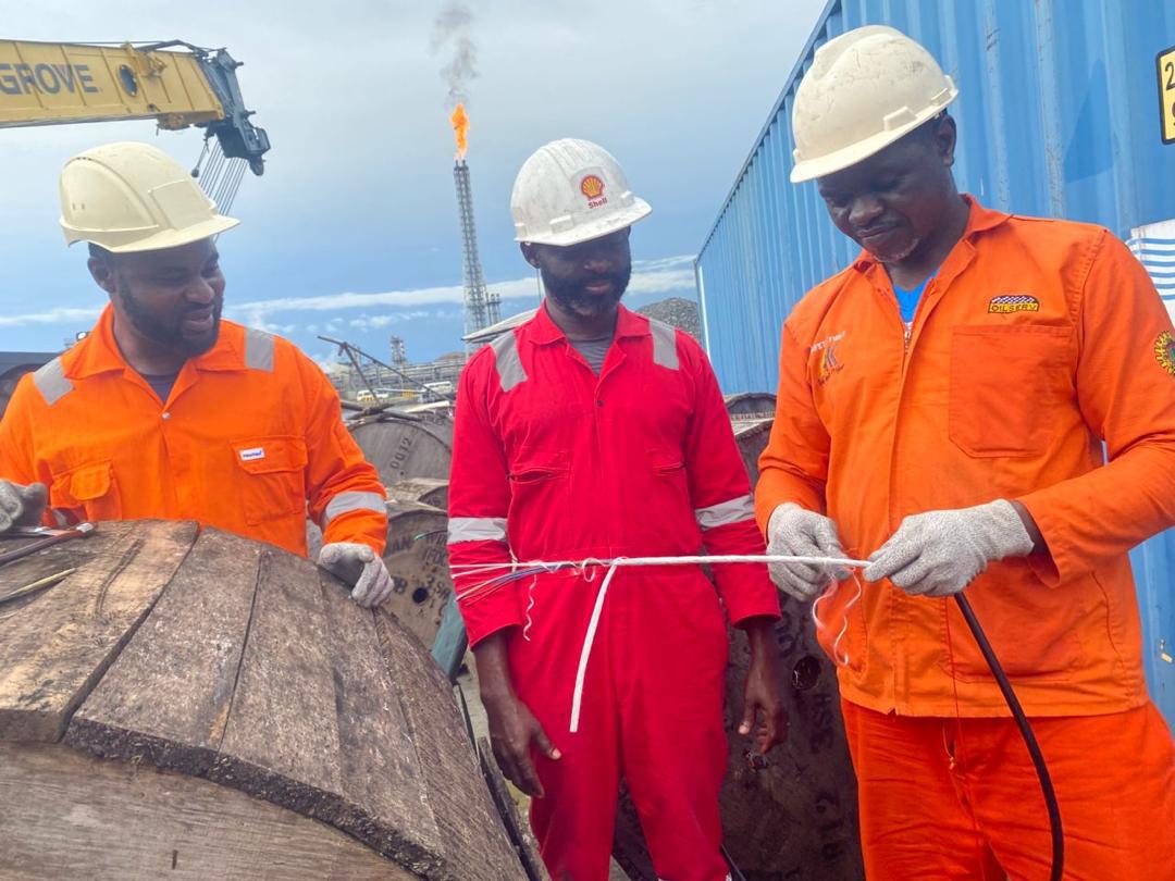 three men with a fibre cable